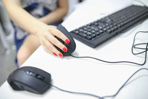 istock girl's hand uses a vertical ergonomic computer mouse joystick. 1194536720