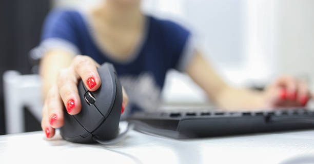 istock girl's hand uses a vertical ergonomic computer mouse joystick. 1194536730