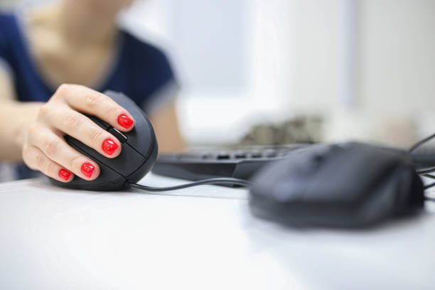 istock girl's hand uses a vertical ergonomic computer mouse joystick. 1194536737