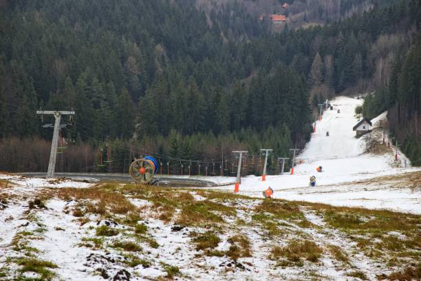 Prepared snow cannons Snow cannons are deployed on the slope and ready for their work. A narrow strip of snow with ski lift between forests. beskid mountains photos stock pictures, royalty-free photos & images