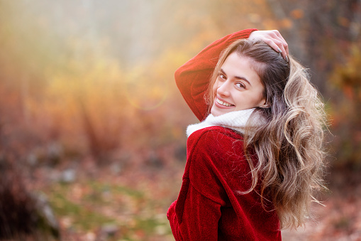 young happy woman smiles in the forest