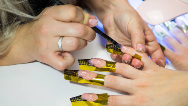 istock Manicure. Master make nail extension. hands closeup 1194537146