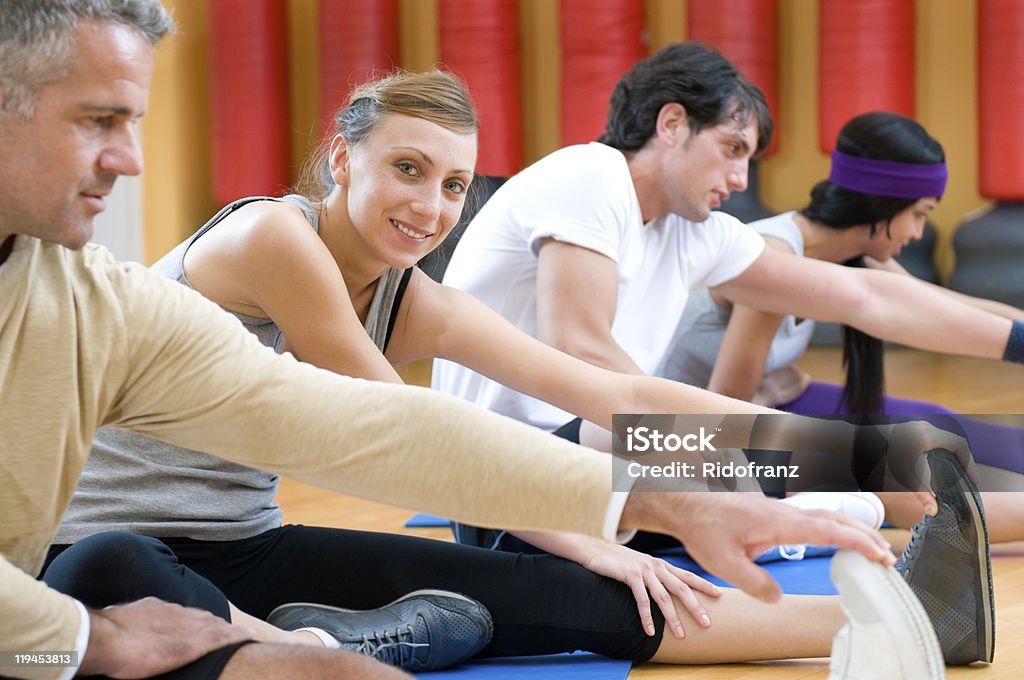 Aerobic stretching exercises at gym  Touching Toes Stock Photo