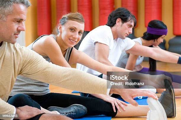 Aerobic Stretching Exercises At Gym Stock Photo - Download Image Now - Touching Toes, Women, 20-29 Years