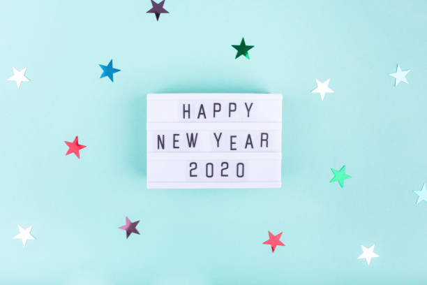 istock Light board with text HAPPY NEW YEAR 2020 on mint color background with stars. 1194539022