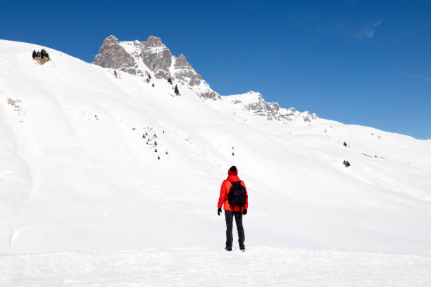 istock Female Backpacker in Snow Covered Mountains 1194539333