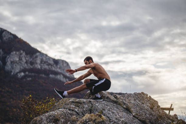 istock Man exercising on top of a  cliff 1194540728