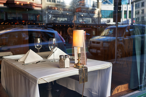 Portland, Oregon, USA - Oct 1, 2019: Vacant table by the window in an old restaurant in downtown Portland.