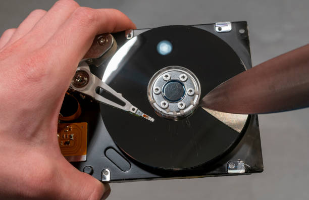 istock Scratches a disassembled hard drive with a knife 1194546792