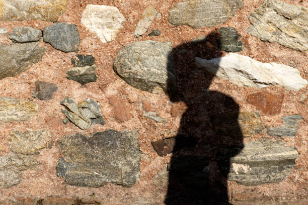 istock shadow of a boy on stone wall 1194549278