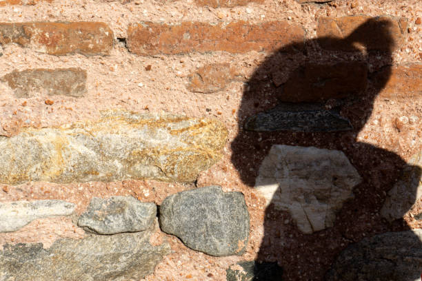 istock shadow of a boy on stone wall 1194550045