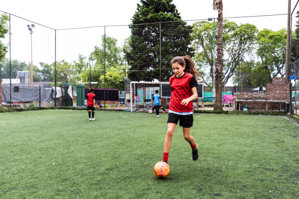 istock Girl training at soccer field 1194550356