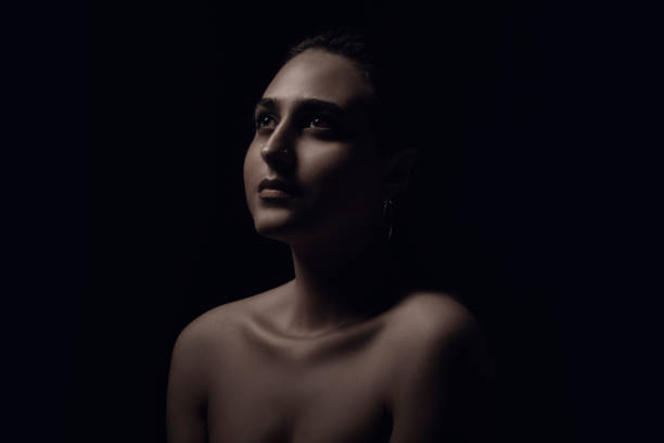 istock woman portrait black background. 1194552648