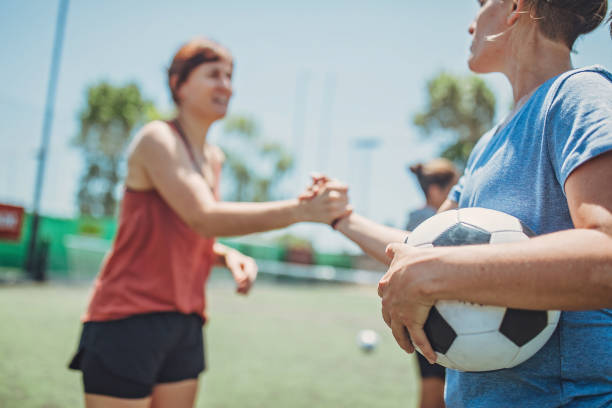 istock Women handshake on a soccer playing field 1194552905