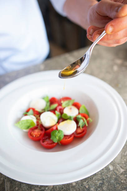 istock Male cook adding details to a salad 1194554140