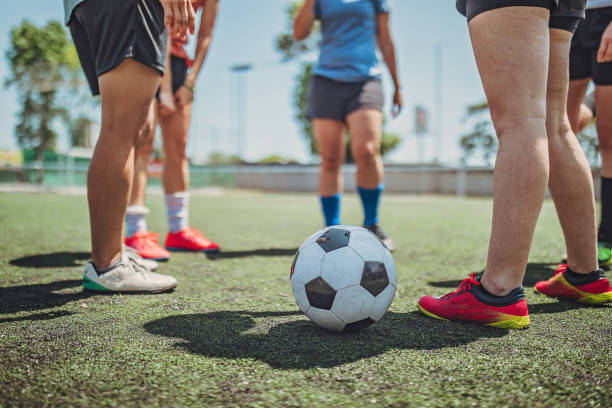 istock Women standing on a soccer playing field 1194554289