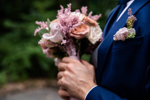 istock Man holding bridal flowers at the wedding 1194559203