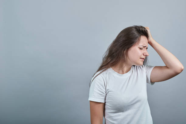 istock Girl has headache and touches head with anxiety 1194563668