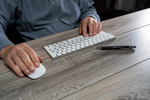 a man at work in front of a computer keyboard