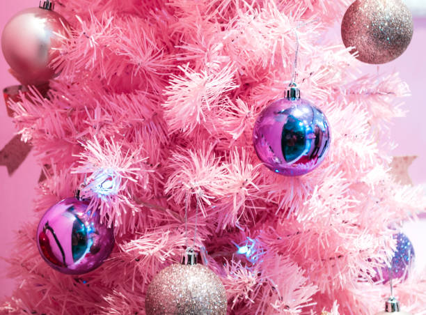 Pink Christmas Tree A minimal Pink Christmas Tree with pink background pink christmas tree stock pictures, royalty-free photos & images
