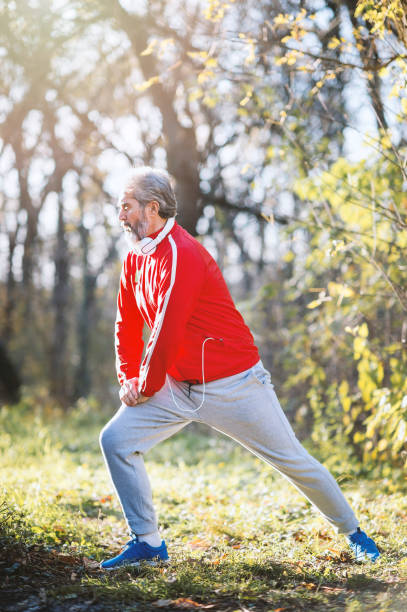 istock Senior man runner stretching outdoors 1194566878
