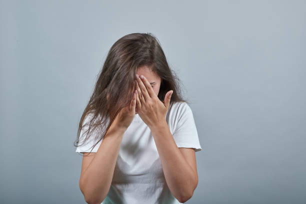 istock Upset lady hides face with two hands 1194566941