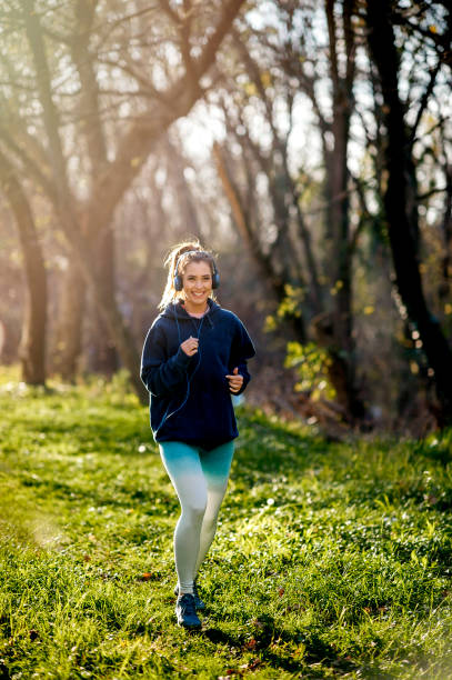 istock Young woman runner stretching outdoors 1194567821