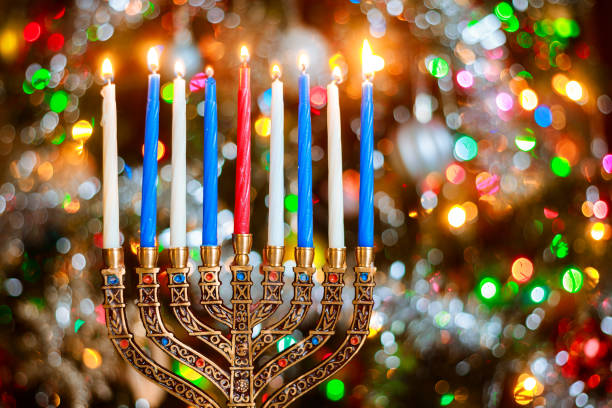 istock Menorah with burning candles for Hanukkah on sparkle background with defocused lights. 1194567894
