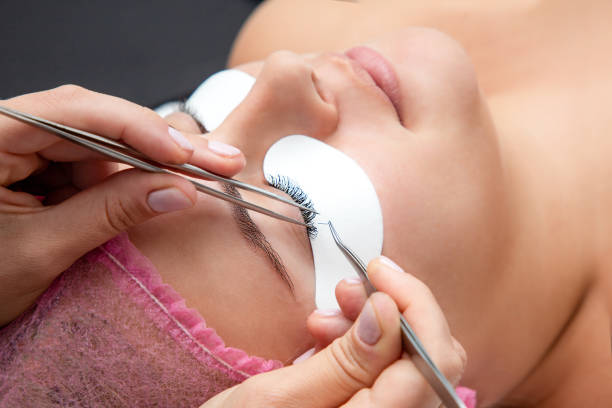 istock Eyelashes extension procedure at spa salon, selective focus, natural volume 1194569641