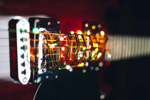 electric guitar with festive Christmas lights, close-up view