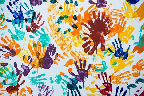istock multi-colored prints of hands smeared with paint on a white wall 1194573490