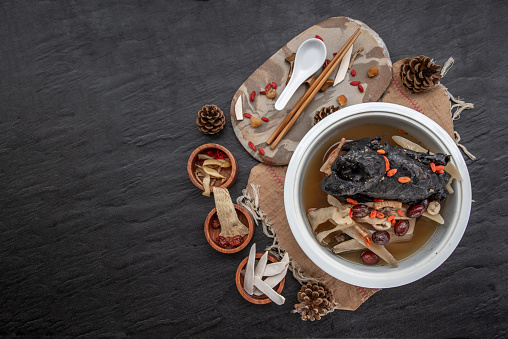 Chinese traditional nourishing health stew, stewed black bone chicken, Chinese black chicken soup, This soup very famous among chinese food and asian food as a healthy soup, food as medicine.  Top view.