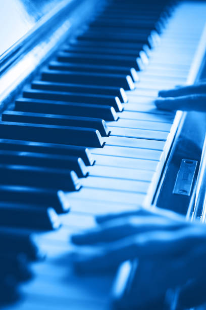 vintage piano keys and hands playing. classic blue tone - blue tint imagens e fotografias de stock