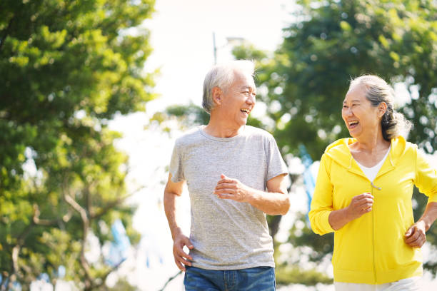 old couple jogging outdoors - chinese ethnicity imagens e fotografias de stock