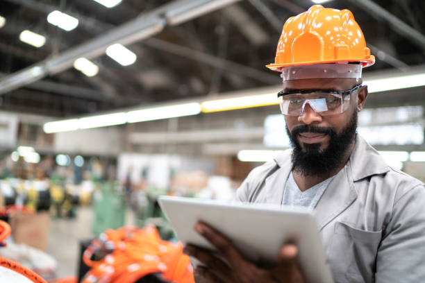 Man working with his digital tablet in the factory