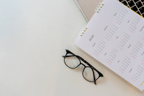 istock close up top view on white calendar 2020 schedule with laptop keyboard  to make appointment meeting or manage timetable each day for design planning work and life concept 1194580521