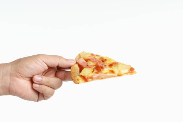 istock Hand holding hawaiian pizza 1194583083