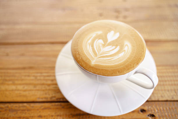 istock Cup of coffee with latte art pattern milk foam 1194583172