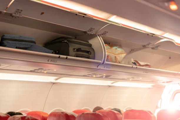 istock Overhead compartment for put luggage on airplane. 1194590258