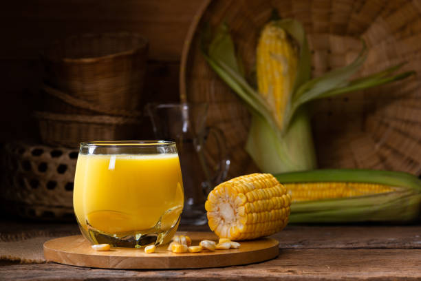 Fresh sweet corn juice (corn milk) and corn on wooden background