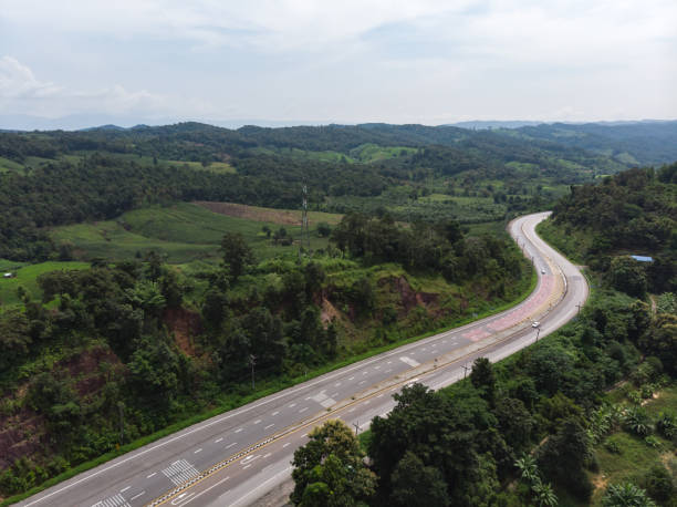 istock Asphalt road through mountain and forest 1194595726