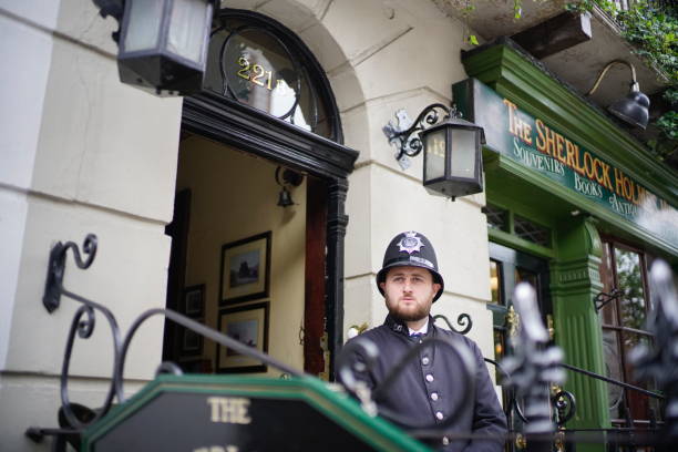 London, UK - 24 June 2019: Staff dressed up with vintage costumes working at the heritage of The Sherlock Holmes Museum, 221B Baker Street.