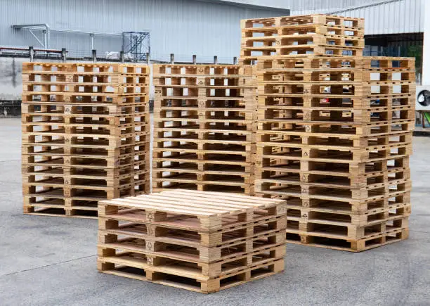 Photo of Stack of wooden pallets at warehouse