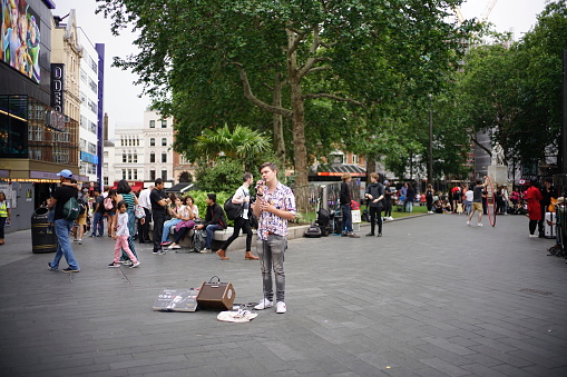 London, UK - 25 June 2019: Street performer performing live music at Leicester Square.