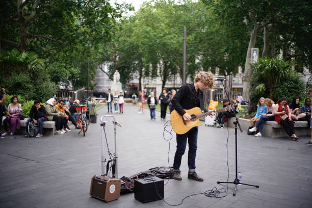 London, UK - 25 June 2019: Street performer performing live music at Leicester Square.