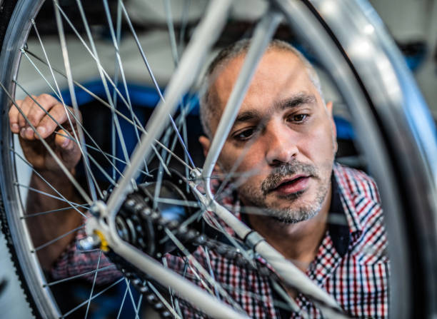 istock Mechanic examining a damaged bicycle wheel. 1194603732