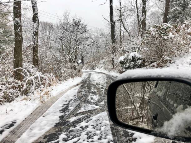 istock Snowy driveway, tire tracks, side view mirror 1194607247