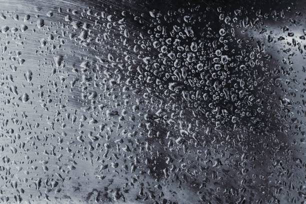 istock Abstract background with water drops on a silver metal sheet. 1194607997