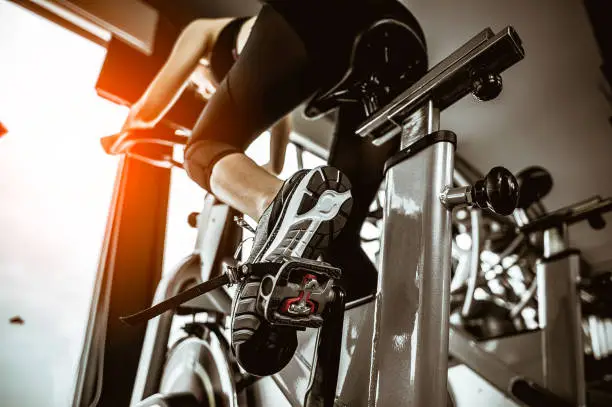 Photo of Fitness woman working out on exercise bike at the gym.exercising concept.fitness and healthy lifestyle