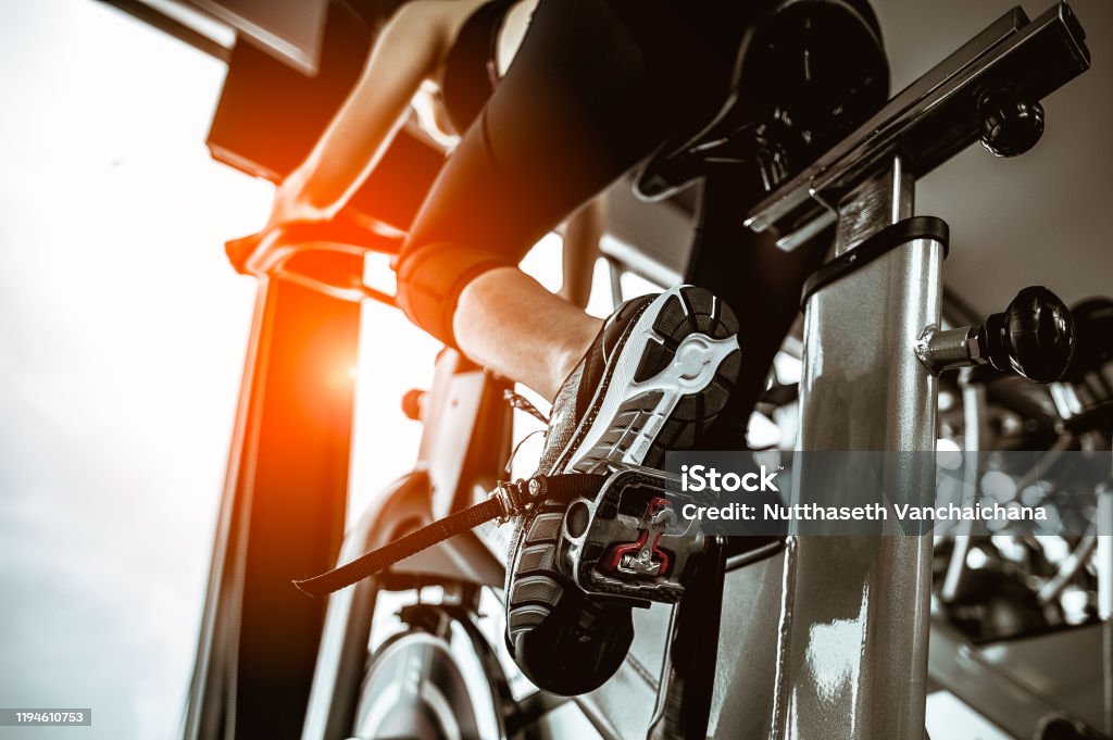Fitness woman working out on exercise bike at the gym.exercising concept.fitness and healthy lifestyle Cardiovascular Exercise Stock Photo